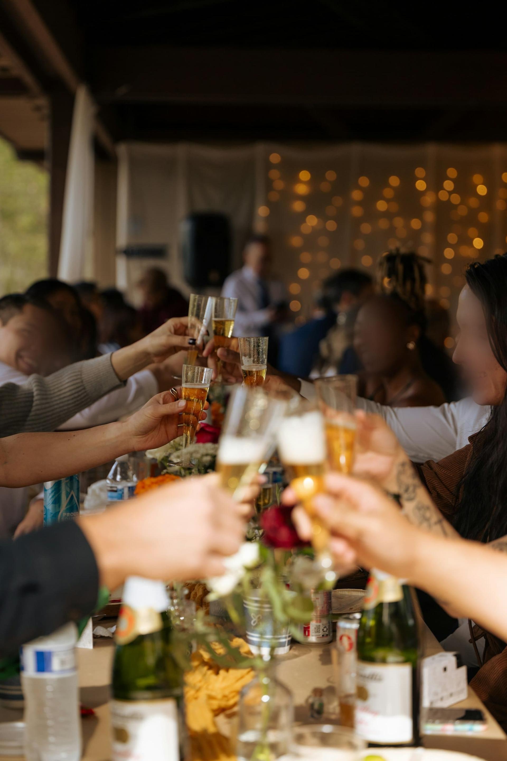 Friends raising glasses in a toast at an evening celebration
