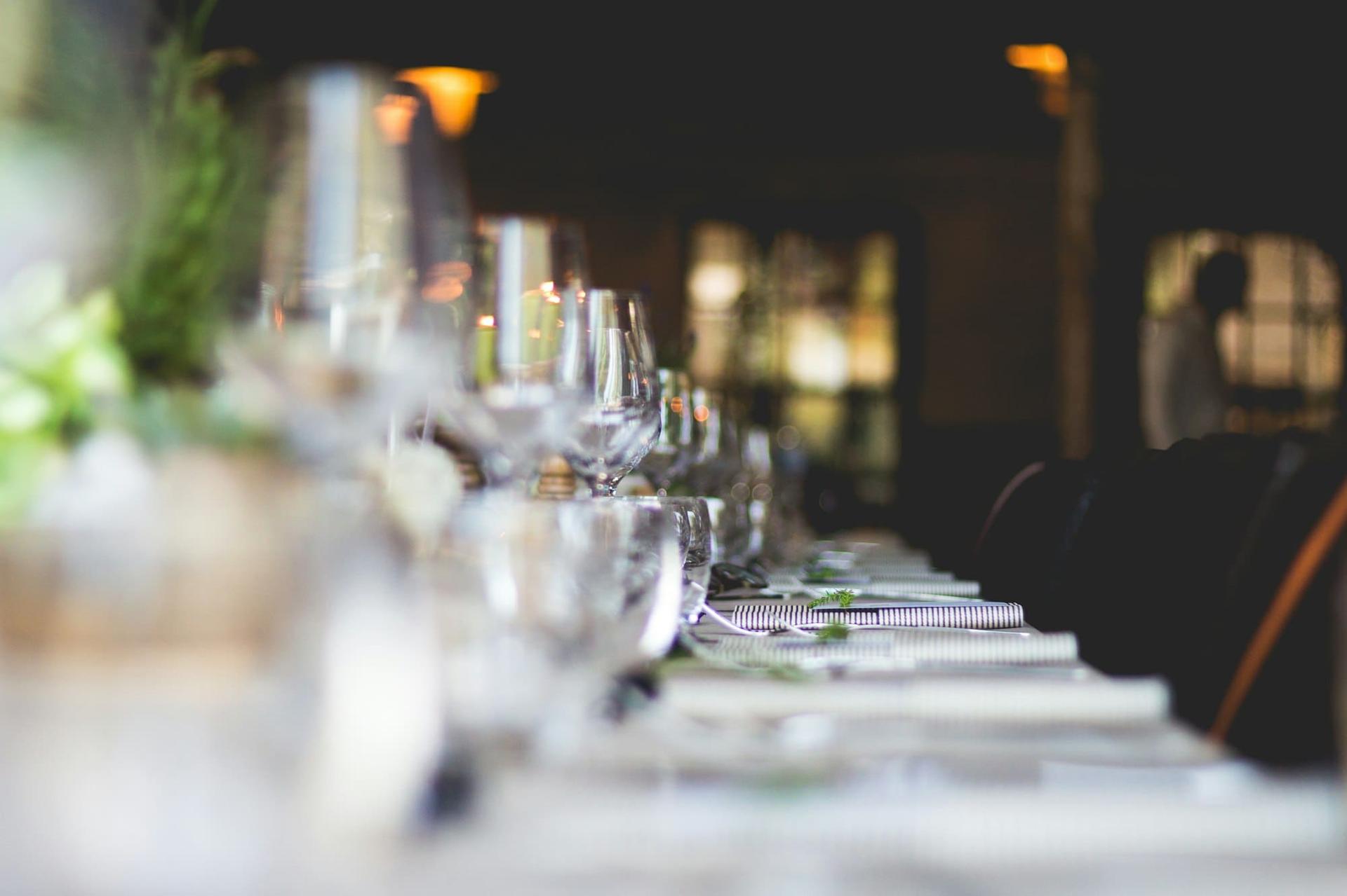 A row of crystal glassware along a long dinner table