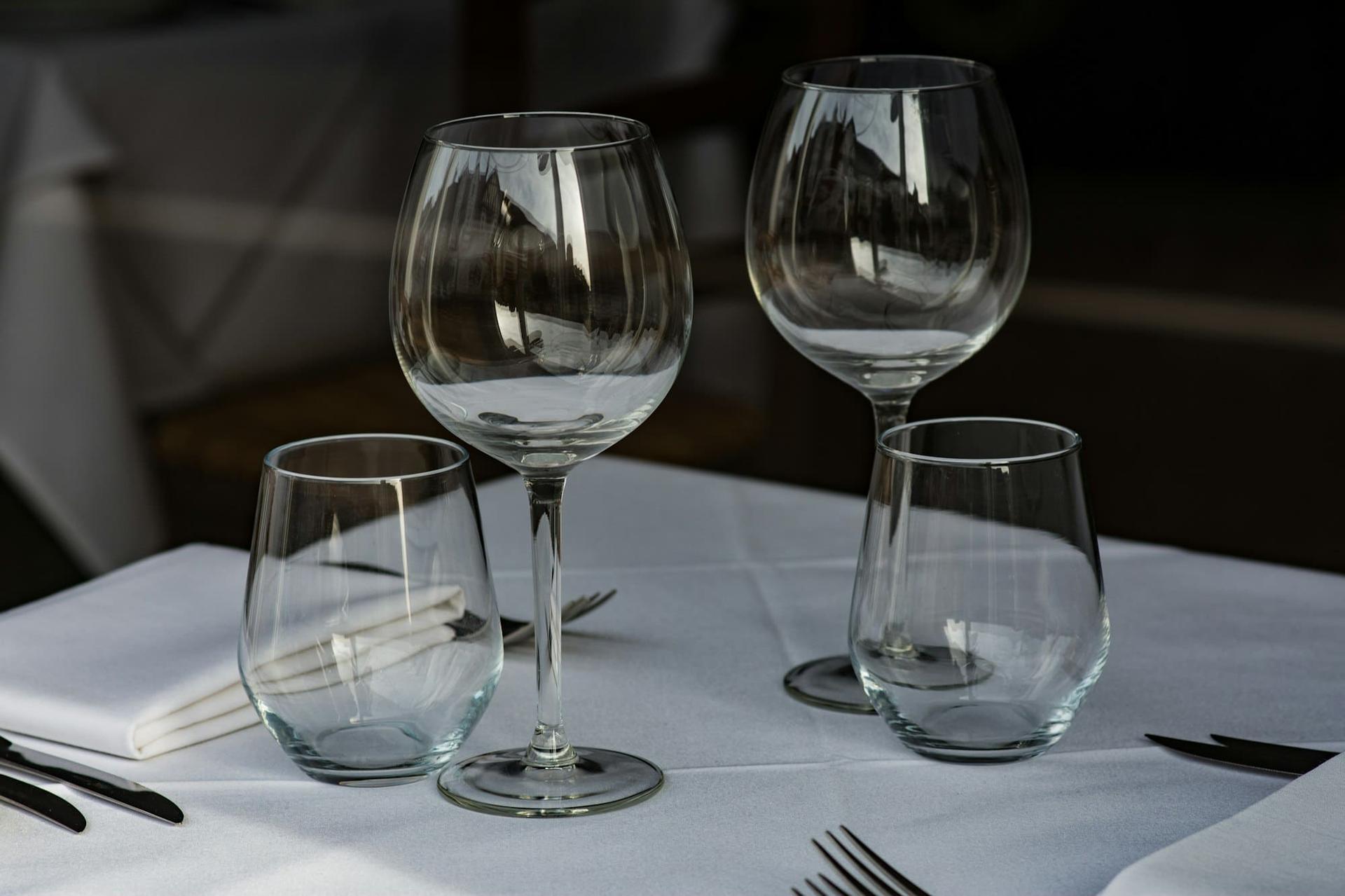 Wine and water glasses on crisp white linen